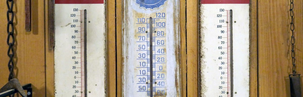 3 old thermometers on a wall