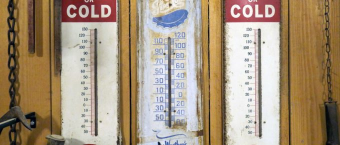 3 old thermometers on a wall